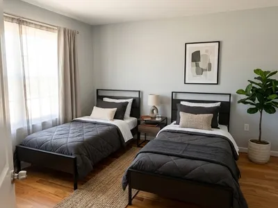 Two twin beds with dark bedding in a DB House bedroom