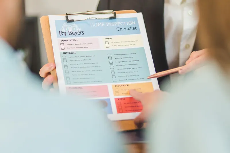 Hands holding a checklist on a clipboard